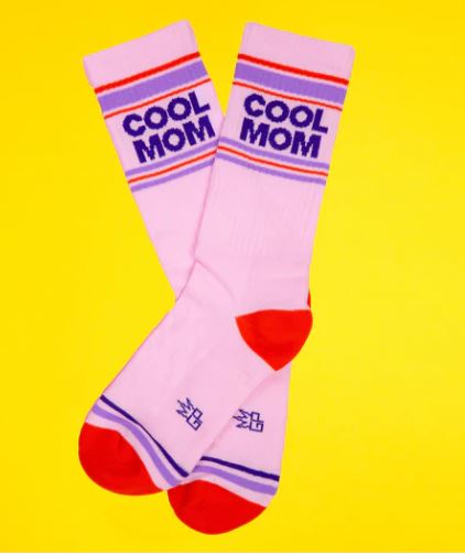 The Blue Dog Posters Cool Mom Gym Crew Socks are unisex pink socks with red toes and heels, blue and red stripes, and "COOL MOM" in bold blue—shown on a bright yellow background—making a fun statement for any occasion.