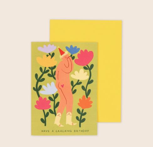 The Cracking Birthday Greeting Card by Blue Dog Posters features a naked person in a red party hat and white socks among colorful flowers, with "Have a cracking birthday" on the front. Includes yellow envelope; card is recyclable.