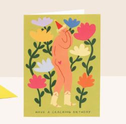 The Cracking Birthday Greeting Card by Blue Dog Posters features a cartoon naked person in a party hat among colorful flowers with "Have a cracking birthday" at the bottom.