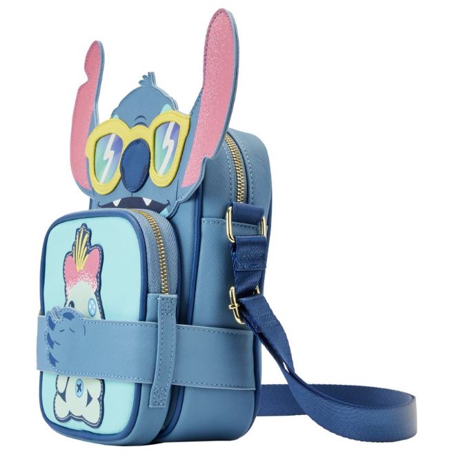 This Blue Dog Posters creation, the Lilo & Stitch - Stitch Beach Crossbuddy, is a blue shoulder bag inspired by a cartoon character. It features large ears and yellow sunglasses. Crafted from vegan leather, this bag showcases a playful blue creature with a pink tuft and includes multiple compartments as well as an adjustable strap for convenience.