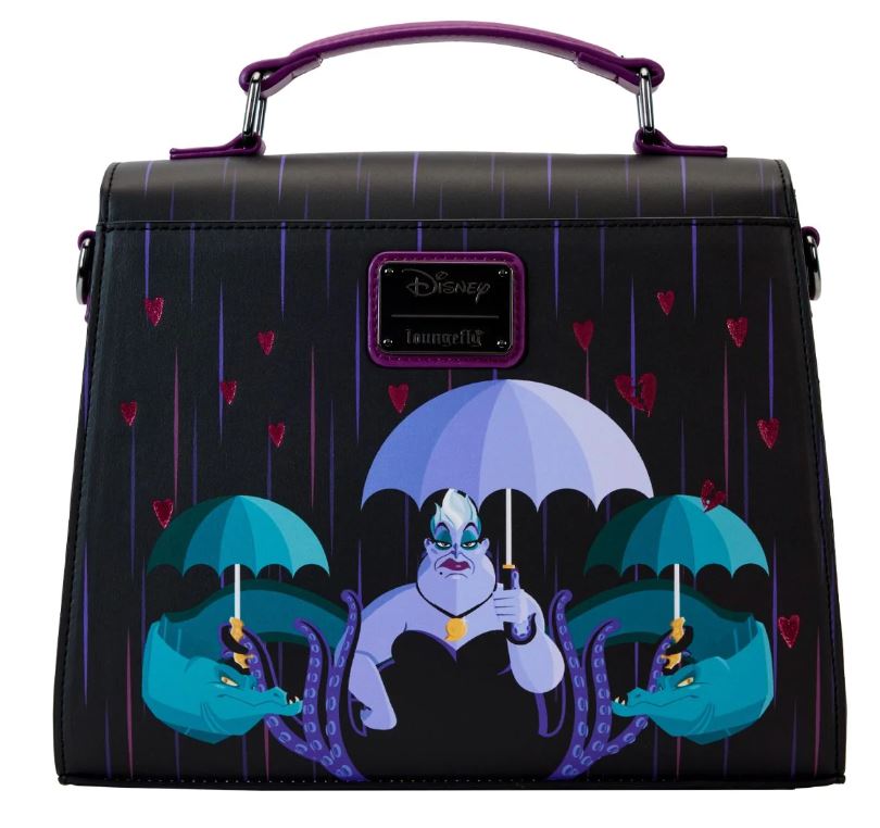 The "Disney Villains Curse Your Hearts Crossbody" by Blue Dog Posters is a black Loungefly bag featuring Disney's Ursula holding a white umbrella, with Flotsam and Jetsam grasping two smaller umbrellas. The background displays a rain effect adorned with scattered red hearts. The bag includes a purple handle and showcases the Disney Loungefly logo.