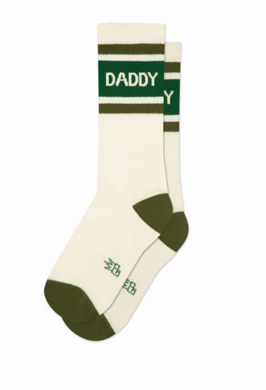 The Daddy Gym Crew Socks by Blue Dog Posters are unisex, featuring white fabric with dark green toes, heels, and stripes. "DADDY" is boldly printed in green at the top. These comfortable socks are ideal for daily wear.