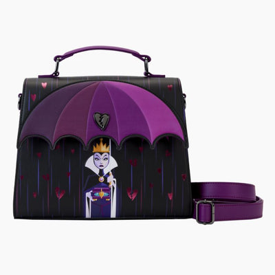 The Disney Villains Curse Your Hearts Crossbody by Blue Dog Posters is an elegant handbag adorned with an evil queen design under a purple and pink umbrella, featuring a broken heart emblem. It comes equipped with a handle and an adjustable shoulder strap, both in purple, and is set against a black background embellished with pink heart details.