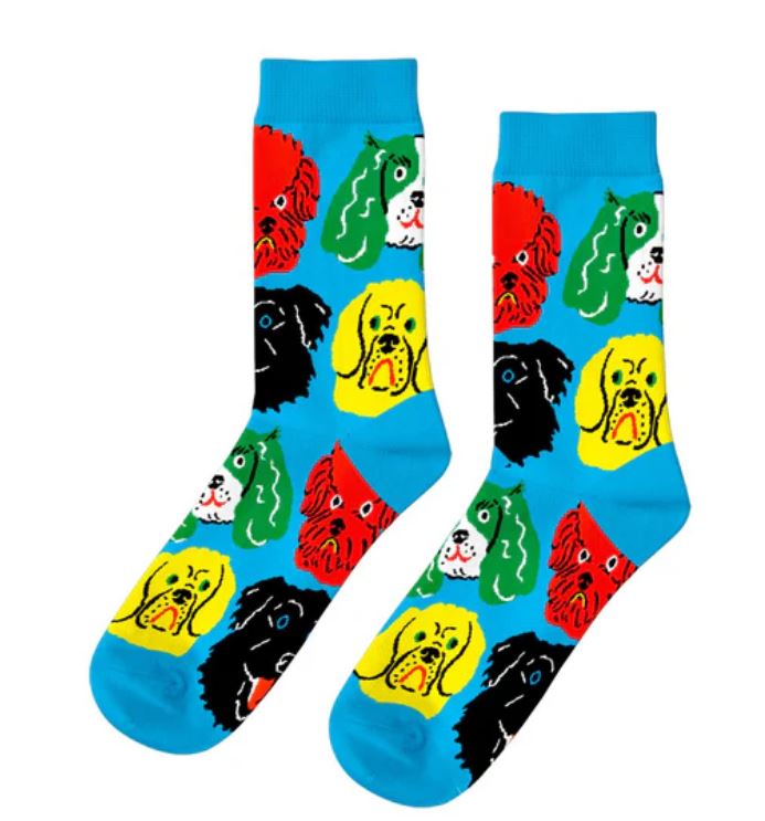 The Kristina Micotti Dogs - Womens Socks by Blue Dog Posters feature bright blue cotton with playful cartoon dog faces in yellow, red, green, black, and white, each showing different expressions in a cheerful repeating pattern.