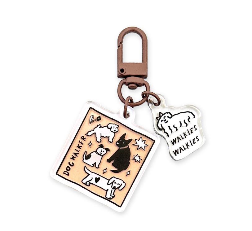 Add cute flair to your keys or bag with Blue Dog Posters’ Dog Walker Walkies Japanese Acrylic Keyring, featuring a rectangular charm with four dog illustrations and “DOG WALKER,” plus a smaller “WALKIES WALKIES” fluffy dog charm.