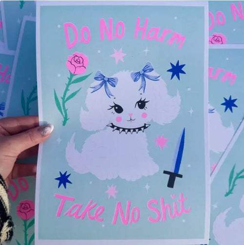 A hand holds the Do No Harm A4 Risograph by Amy Hastings from Blue Dog Posters, showing a white dog with blue bows amid stars, roses, and a blue knife. "Do No Harm, Take No Shit" in pink text. Printed on recycled coffee cup paper.
