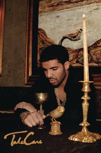 A man sits at a table adorned with a tall candle, a golden goblet, and a small golden statue of a bird. He appears contemplative and is dressed in dark clothing with gold jewelry. A "Drake - Take Care" Hip Hop Poster from MUS 167 is displayed at the bottom left of the image.