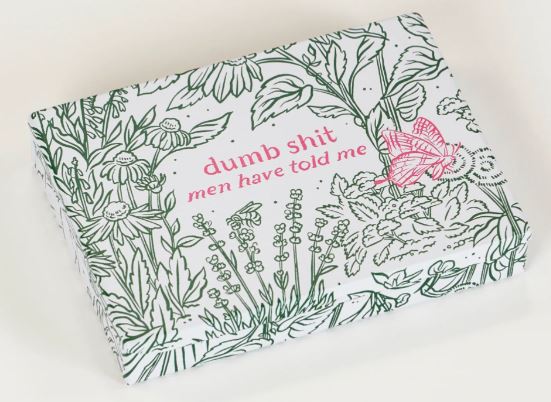 The Dumb Shit Small Tin by Blue Dog Posters features a white background, green floral designs, pink "dumb shit men have told me" text, and a pink butterfly—perfect compact storage for keepsakes or notes.
