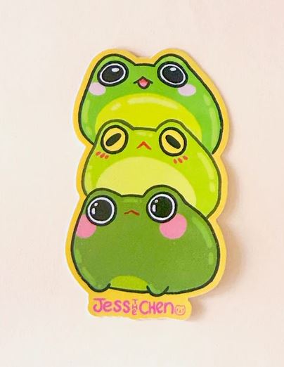 Three cute, cartoon-style green frogs are stacked in this adorable Frog Stack Vinyl Single Sticker by Jess Chen, from Blue Dog Posters. The name "Jess Chen" appears in yellow at the bottom of the image.