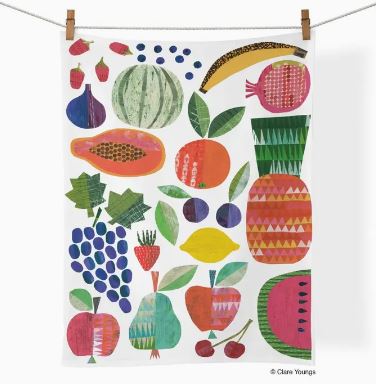 The Werkshoppe Tea Towel Fruit Stand by Blue Dog Posters features colorful illustrated fruits and hangs with clothespins, making it a vibrant, charming fruit-themed cotton kitchen towel.