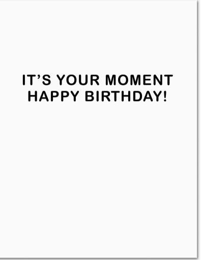 The You're Golden Greeting Card by Blue Dog Posters is a white folded card made from recycled paper with bold black text in the center that reads, "IT'S YOUR MOMENT HAPPY BIRTHDAY!.