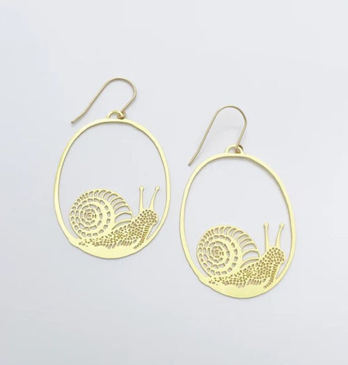 A pair of Snails in Gold Dangle Earrings by Blue Dog Posters showcases a whimsical design of slippery snails elegantly encased in oval frames against a plain white backdrop.
