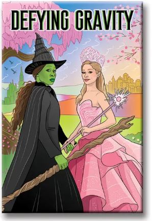 The Wicked Defying Gravity Magnet by Blue Dog Posters, made in the USA, shows two witches—one green-skinned in black, one in pink with a wand—standing by a castle and trees, with "DEFYING GRAVITY" at the top.