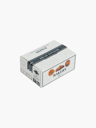 A closed Japanese Mini Sticker Box Bakery by Blue Dog Posters sits on a white background. The white rectangular box, decorated with images of bread and pastries, has a dark top band labeled "Bread Stickers.