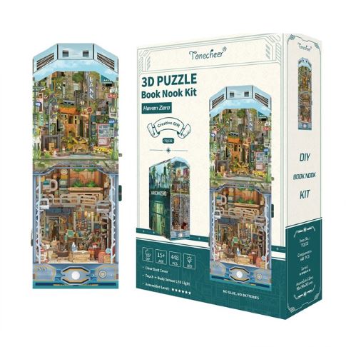 The Haven Zero Large Book Nook by Blue Dog Posters is displayed beside its packaging. This post-apocalyptic DIY kit features a detailed, colorful urban diorama, with the box providing age and assembly details.