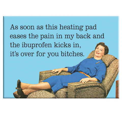 A woman in a blue dress relaxes on a recliner, smiling. The text reads: "Heating Pad & Ibuprofen Magnet by Blue Dog Posters—when the pain fades, it's over for you bitches.