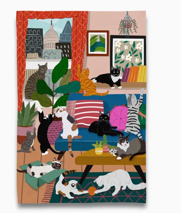 A vibrant scene of twelve playful cats in a cozy living room, inspired by the House of Kitty Cats Tea Towel from Blue Dog Posters—just like the lively cat-filled design brought to life.
