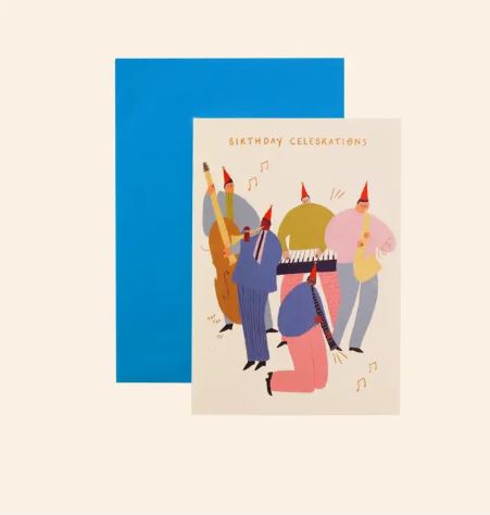 The Jazz Birthday Celebrations Greeting Card by Blue Dog Posters features five people in party hats playing instruments and comes with a bright blue envelope. The recyclable card says “Birthday Celebrations” at the top.