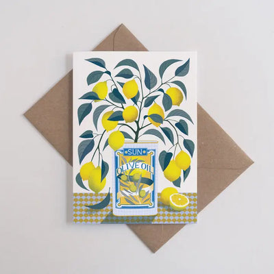 The Lemon Tree Greeting Card - Vicki Johnson by Blue Dog Posters is an A6 card featuring a lemon tree in a blue oil can, displayed on a recycled manilla envelope. Printed on FSC certified card.