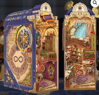 The Magical Library Large Book Nook by Blue Dog Posters features intricate bookshelves, winding stairs, chandeliers, and mystical symbols—an enchanting diorama to bring whimsical fantasy decor to your shelf.