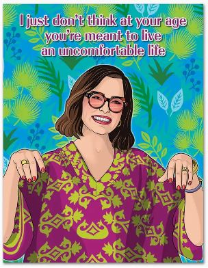 The White Lotus Parker Posey Live It Up Birthday Card by Blue Dog Posters features an illustrated woman in glasses and a patterned top, smiling on a leafy backdrop. Made from recycled paper, it reads: “I just don’t think at your age you’re meant to live an uncomfortable life.”.