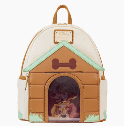 The Disney I Heart Dogs Mini Backpack by Blue Dog Posters is designed to resemble a doghouse complete with a bone above the entrance. The lower front portion showcases an image of beloved Disney dogs peeking out of the doghouse, accented with triple lenticular details in brown, green, and white. For added convenience, it features a top handle and adjustable straps.