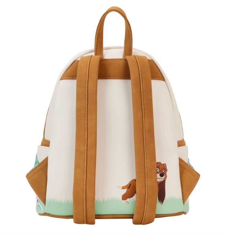 The Disney I Heart Dogs Mini Backpack by Blue Dog Posters features a cream body with tan straps and accents. It showcases an adorable illustration of a brown and white dog standing on green grass at the bottom. This mini backpack also includes two side pockets and a top loop handle, making it a perfect addition to any Disney Dogs fan's collection.