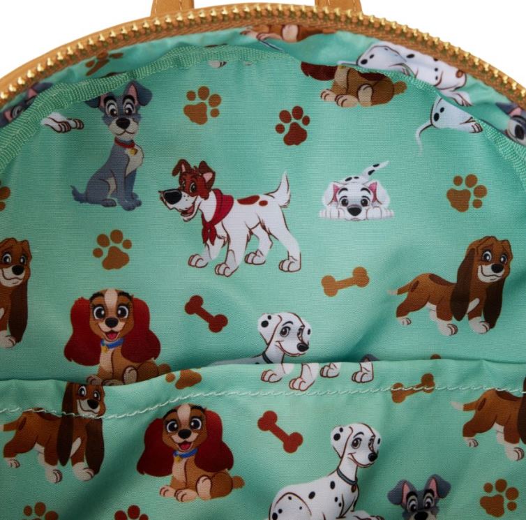 A close-up of the Disney I Heart Dogs Mini Backpack by Blue Dog Posters showcases a lively fabric pattern with various cartoon dogs, including Disney Dogs. Set against a green background, the design features dogs of different breeds and colors, along with paw prints and bones. The image perfectly captures the playful and colorful nature suitable for this mini backpack or a triple lenticular print.