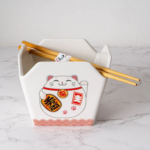 The Takeout Box Serving Bowl With Chopsticks LUCKY CAT by Blue Dog Posters is a white ceramic reusable bowl featuring a smiling lucky cat with a gold coin and red symbols, with wooden chopsticks resting on top. Microwave safe.