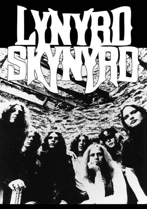 Black and white image of rock band Lynyrd Skynyrd. Seven members are posing, with the band name in stylized, bold letters above them. Some are seated and some are standing inside a rustic, stone-walled room. This striking MUS 253 Lynyrd Skynyrd - Group rock poster is perfect for any music collection.