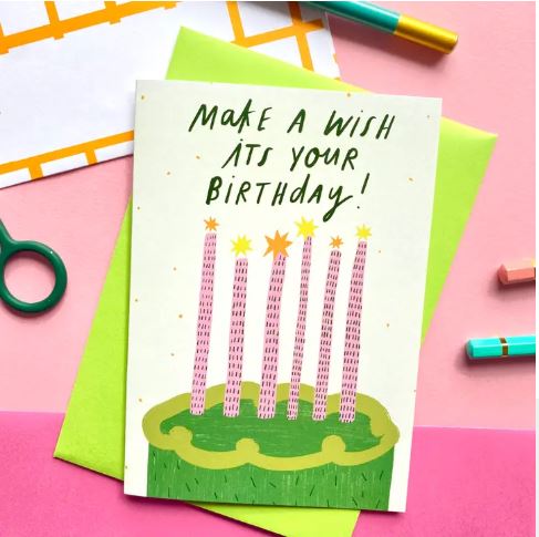 The Make a Wish Cake Greeting Card by Blue Dog Posters features pink candles on a green cake with the message "Make a wish, it's your birthday!" and comes with an FSC-certified green envelope.