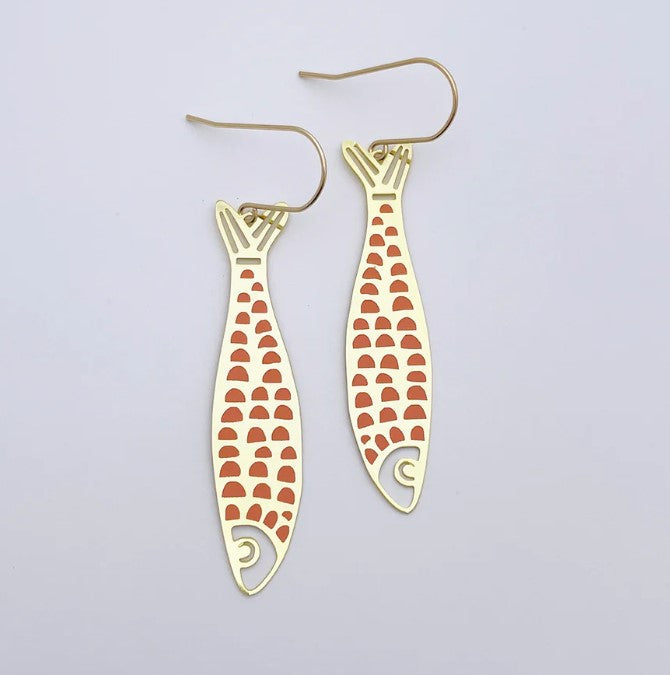 Denz Midi Fishy Orange Gold Pink Earrings by Blue Dog Posters: Minimalist ocean-inspired earrings featuring gold fish shapes with orange scales, crafted from recycled stainless steel, shown on a white background.