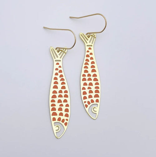 Denz Midi Fishy Orange Gold Pink Earrings by Blue Dog Posters: Minimalist ocean-inspired earrings featuring gold fish shapes with orange scales, crafted from recycled stainless steel, shown on a white background.