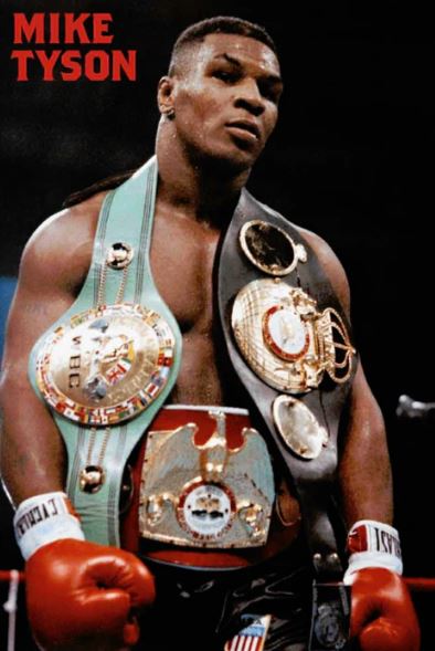 A muscular boxer stands in the ring with three championship belts, looking serious. "Mike Tyson - Belts" by SPO 059 appears in bold red at the top left of this premium gloss Boxing Poster from our Sport Collection.