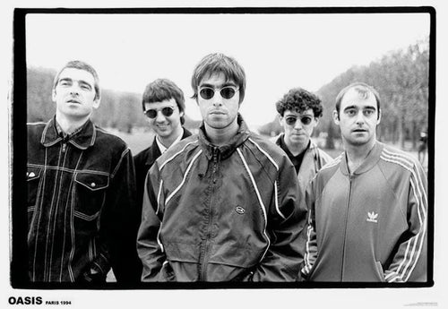 Oasis - Paris 1994 by MUS 137 features five men outdoors in a black-and-white photo, all in casual jackets and sunglasses. The central figure faces the camera. An iconic addition to any music collection or as a large regular poster.