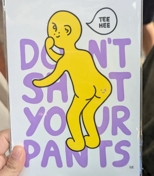A cheeky yellow cartoon reveals a smiley face on its butt with "TEE HEE" in a speech bubble and "DON'T SH*T YOUR PANTS" in purple text. Embrace fun with the Don't Shit Your Pants A5 Archival Print by Inner Baby from Blue Dog Posters.