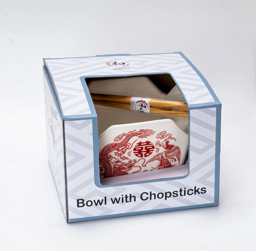 The Takeout Box Serving Bowl With Chopsticks PHOENIX by Blue Dog Posters is a microwave safe ceramic bowl with red phoenix designs and wooden chopsticks, all visible through a clear window on the packaging.