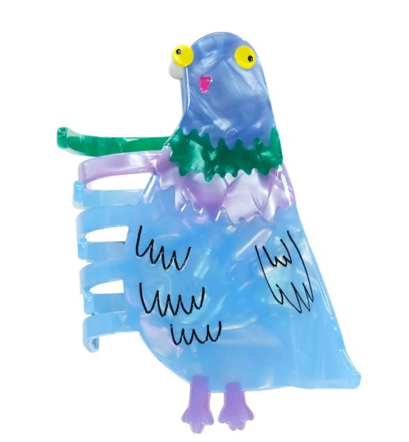 The Bird Brain Pigeon Hair Claw by Blue Dog Posters features a whimsical blue pigeon with yellow eyes and purple feet, adding playful flair to any outfit as both a brooch and a unique acetate hair accessory.