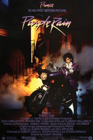 MUS 205’s "Prince - Purple Rain" poster features Prince on a motorcycle in purple at night, with a misty street and a woman in a doorway—an iconic addition for music fans or collectors of large posters.