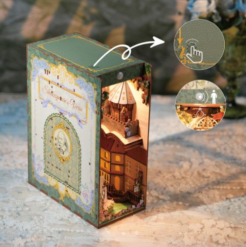 The Shakespears' Verse Large Book Nook Tonecheer by Blue Dog Posters is a decorative book-shaped box with touch controls, soft lighting, and circular insets that reveal a detailed miniature house scene and textured details inside.