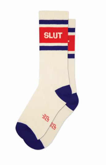 The Blue Dog Posters Slut Gym Crew Socks are cream natural cotton unisex socks with navy toes, heels, and stripes, topped by a bold red band reading "SLUT" in white—perfect for slut walks or making a statement every day.