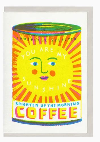 The "You are my Sunshine Coffee Riso Card" from Blue Dog Posters features bright, colorful artwork of a coffee can with a smiling face. The can bears the phrases "Carefully Selected" and "You Are My Sunshine". Perfect for any coffee lover, the bottom text reads "Brighten Up The Morning Coffee," adorned in vibrant yellow, pink, blue, and green colors.