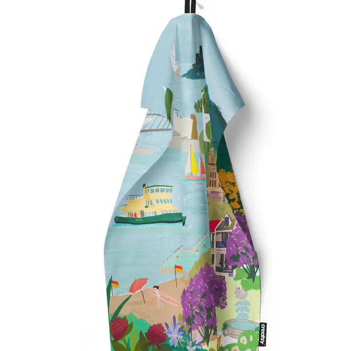 Brighten your kitchen with the Sydney Icons Kitchen Tea Towel from Blue Dog Posters, featuring colorful coastal scenes with beaches, boats, and lively greenery—ideal for adding Australian charm to your decor.