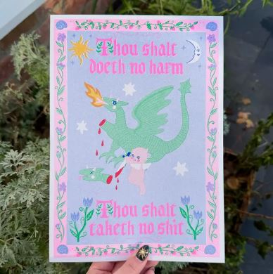 A hand holds the "Taketh No Shit A4 Risograph" by Amy Hastings from Blue Dog Posters, showing a green dragon and unicorn with the words "Thou shalt doeth no harm, Thou shalt taketh no shit," on recycled paper. Made in the UK.