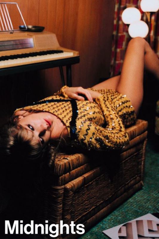 A woman in a gold sequined top lounges on a wicker bench next to a keyboard piano, creating the perfect Pop Music Poster. "Midnights" by Taylor Swift (MUS 326) appears in white text at the bottom left corner.