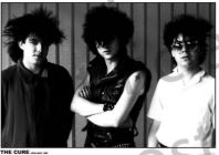 The Cure Holland by MUS 066 features three people with spiky hair and dark outfits posing against a striped wall. The black and white poster’s central figure wears sunglasses, making it a bold addition to any music collection.
