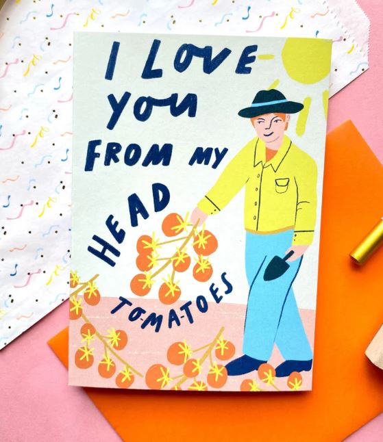 The "I Love You From My Head Tomatoes Card" by Blue Dog Posters features a cute person in a hat and yellow shirt holding tomato vines, with playful blue "I love you from my head tomatoes" text. Blank inside for your personal message.