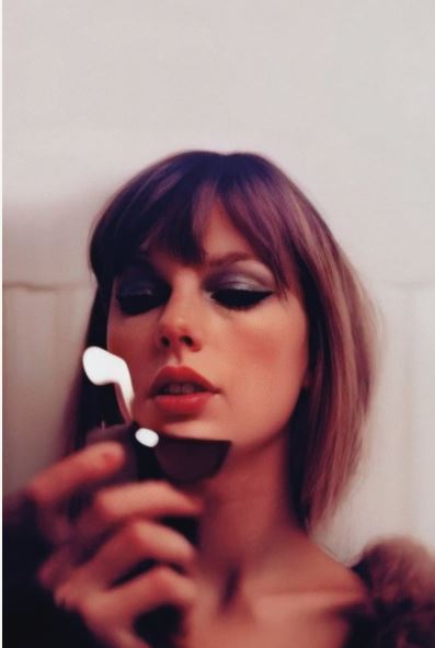 A woman with bobbed hair and bold eye makeup gazes down at a Taylor Swift - Midnights Lighter from MUS 274, holding it open. The slightly blurred image evokes the dreamy, vibrant style of a pop music poster.