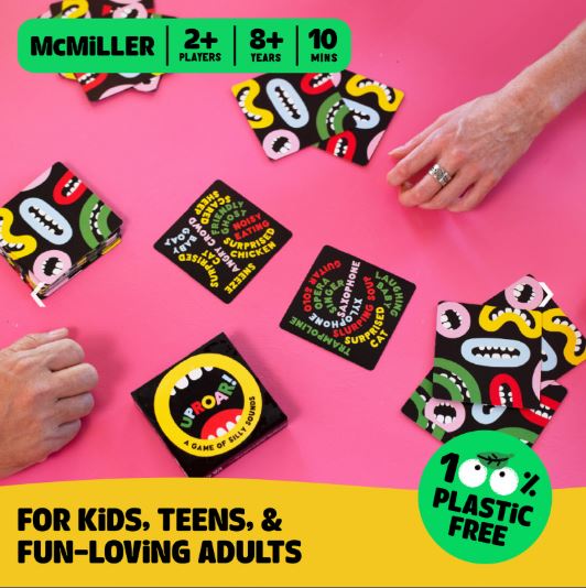 Uproar by Blue Dog Posters is a hilarious, 100% plastic-free card game for kids, teens, and fun-loving adults. Play with 2+ people, ages 8+, in just 10 minutes! Cartoon mouth cards spread on a pink table as hands reach to play.