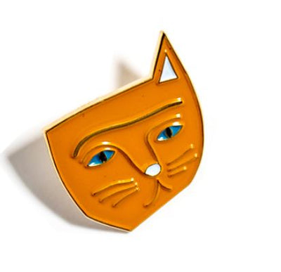 The Vincat Van Gogh Enamel Pin by Blue Dog Posters is a brightly colored orange enamel pin shaped like a stylized cat's face, complete with blue eyes, whiskers, and a content expression. Reminiscent of Vincent van Gogh’s vibrant palette, the minimalistic design by Nia Gould features clean lines and a smooth finish, giving the cat an abstract yet playful appearance.